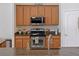 Modern kitchen features stainless steel appliances and wood cabinets at 13517 Hunters Point St, Spring Hill, FL 34609