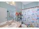 Clean bathroom with a shower/tub combo and colorful curtain at 13517 Hunters Point St, Spring Hill, FL 34609