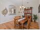 Bright dining room with hardwood floors and wood table with seating for six at 13517 Hunters Point St, Spring Hill, FL 34609