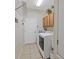 Functional laundry room with washer, dryer, and overhead storage at 13517 Hunters Point St, Spring Hill, FL 34609