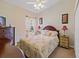Cozy bedroom with a floral comforter and wooden furniture at 13517 Hunters Point St, Spring Hill, FL 34609