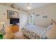 Seashell-themed bedroom with a comfortable bed and window seat at 13517 Hunters Point St, Spring Hill, FL 34609