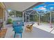 Enjoy this screened patio with colorful chairs and a bench at 13517 Hunters Point St, Spring Hill, FL 34609