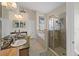 Elegant bathroom with double vanity, soaking tub, and walk-in shower at 13517 Hunters Point St, Spring Hill, FL 34609