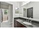 Bathroom with dark vanity and granite countertop at 2039 Park Crescent Dr, Land O Lakes, FL 34639