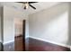 Bright bedroom with dark hardwood floors and a walk-in closet at 2039 Park Crescent Dr, Land O Lakes, FL 34639