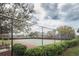 Exterior view of a community basketball court with lush landscaping and a well-maintained fence at 10595 Marsha Dr, New Port Richey, FL 34655
