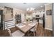 Dining area with a wooden table, chairs, chandelier, and open view to the kitchen at 10595 Marsha Dr, New Port Richey, FL 34655