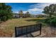 Community green space with a bench, offering a relaxing view of townhomes in the distance at 10595 Marsha Dr, New Port Richey, FL 34655