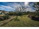 Lush green space with mature trees and vegetation, creating a serene natural setting at 10595 Marsha Dr, New Port Richey, FL 34655