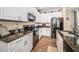 Well-equipped kitchen with granite counters, white cabinetry, and stainless steel appliances at 10595 Marsha Dr, New Port Richey, FL 34655