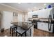Modern kitchen featuring a granite island with seating and stainless-steel appliances at 10595 Marsha Dr, New Port Richey, FL 34655