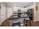 Modern kitchen with granite countertops, white cabinetry, and stainless steel appliances at 10595 Marsha Dr, New Port Richey, FL 34655