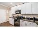 Granite countertops, modern appliances, and white cabinets accentuate this kitchen's charm at 10595 Marsha Dr, New Port Richey, FL 34655