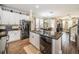 Open kitchen layout with stainless steel appliances, granite counters and access to the dining room at 10595 Marsha Dr, New Port Richey, FL 34655
