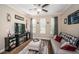 Inviting living room features a cozy sofa, decorative accents, and a modern ceiling fan at 10595 Marsha Dr, New Port Richey, FL 34655