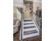 Interior staircase featuring hardwood steps and decorative accents leading upstairs at 10595 Marsha Dr, New Port Richey, FL 34655