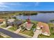 An aerial view of a single Gathering home overlooking a beautiful lake and mature landscaping at 1717 Daylily Dr, Trinity, FL 34655