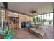 Covered patio with brick pavers, a ceiling fan and an outdoor dining set for relaxing and entertaining at 1717 Daylily Dr, Trinity, FL 34655