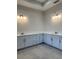 Spacious bathroom with double vanity and light grey cabinets at 19364 Sheltered Hill Dr, Brooksville, FL 34601