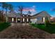 Inviting single-story home with brick accents, paver driveway, and well-manicured lawn at dusk at 19364 Sheltered Hill Dr, Brooksville, FL 34601