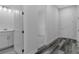 Hallway with bathroom vanity and luxury vinyl flooring leading into the bedroom at 19364 Sheltered Hill Dr, Brooksville, FL 34601