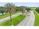 Gated community entrance with palm trees and guard house at 19364 Sheltered Hill Dr, Brooksville, FL 34601