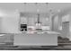 Modern kitchen features a large center island with pendant lighting and stainless steel appliances at 19364 Sheltered Hill Dr, Brooksville, FL 34601
