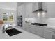 Modern kitchen with white cabinets, stainless steel appliances, and a spacious island at 19364 Sheltered Hill Dr, Brooksville, FL 34601