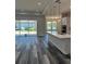 Open kitchen with large island, stainless appliances, and seamless flow to the living area and outdoor spaces at 19364 Sheltered Hill Dr, Brooksville, FL 34601
