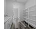 Walk-in pantry features sink, counter space and custom white shelving for organized storage at 19364 Sheltered Hill Dr, Brooksville, FL 34601