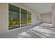 Spacious covered patio with large sliding glass doors, offering an indoor-outdoor living experience at 19364 Sheltered Hill Dr, Brooksville, FL 34601