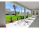 Covered patio overlooking a lush, green lawn and other homes in the neighborhood at 19364 Sheltered Hill Dr, Brooksville, FL 34601