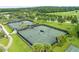 Aerial view of community tennis courts with lush landscaping at 19364 Sheltered Hill Dr, Brooksville, FL 34601