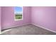 Spacious bedroom with light purple walls and grey carpeting at 5242 Fez Ct, Brooksville, FL 34602