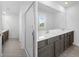 Modern bathroom with double vanity, shower, and grey wood-look flooring at 5242 Fez Ct, Brooksville, FL 34602