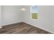 Simple dining area with wood-look floors and a window with blinds at 5317 Cricket Rd, Brooksville, FL 34602