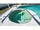 Relaxing in-ground hot tub with custom tile and mosaic designs and sparkling, clear water at 6206 Soaring Ave, Temple Terrace, FL 33617