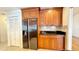 Spacious kitchen featuring custom wood cabinetry, granite countertops, and stainless steel refrigerator at 6206 Soaring Ave, Temple Terrace, FL 33617