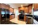 Updated kitchen with stainless steel appliances, granite countertops, and warm wood cabinets at 6206 Soaring Ave, Temple Terrace, FL 33617