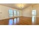 Bright living room with hardwood floors, chandelier, and plantation shutters at 6206 Soaring Ave, Temple Terrace, FL 33617