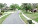 Aerial view of a quiet neighborhood street showcasing mature trees and manicured lawns at 6206 Soaring Ave, Temple Terrace, FL 33617
