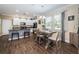 Open kitchen with white cabinets, granite countertops, and a dining area at 10595 Marsha Dr, New Port Richey, FL 34655