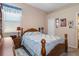 Bright bedroom featuring a wooden bed frame and neutral color scheme at 1638 Swamp Rose Ln, Trinity, FL 34655