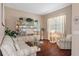 Charming sitting area with hardwood floors, comfortable seating, and built-in shelving at 1638 Swamp Rose Ln, Trinity, FL 34655