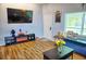 Living room with TV, fireplace, and wood-look flooring at 1775 Cupecoy Cir # O4, Lutz, FL 33558