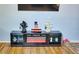 Black entertainment center with a fireplace and decorative items at 1775 Cupecoy Cir # O4, Lutz, FL 33558