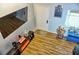 Spacious entryway with large TV and wood-look floors at 1775 Cupecoy Cir # O4, Lutz, FL 33558