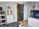 Bedroom with barn door, white dresser, and wood floors at 1775 Cupecoy Cir # O4, Lutz, FL 33558
