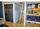 Loft with access ladder, kitchen view, and wood floors at 1775 Cupecoy Cir # O4, Lutz, FL 33558